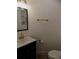 Stylish powder room featuring a black vanity, gold fixtures, and elegant artwork, offering a touch of luxury at 3512 Osprey Cove Dr, Riverview, FL 33578
