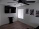Bright bedroom featuring modern ceiling fan, decorative wall art, and light wood-look flooring at 3512 Osprey Cove Dr, Riverview, FL 33578