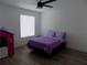 Cozy bedroom featuring plush purple bedding and light wood-look flooring at 3512 Osprey Cove Dr, Riverview, FL 33578