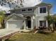 Charming two-story home with well-maintained landscaping, mature palm trees, and a two car garage at 3512 Osprey Cove Dr, Riverview, FL 33578