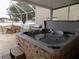 Outdoor hot tub and patio with lake view, perfect for relaxation and entertaining at 3512 Osprey Cove Dr, Riverview, FL 33578