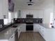 Modern kitchen featuring stainless appliances, updated cabinets, and sleek backsplash at 3512 Osprey Cove Dr, Riverview, FL 33578