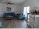 Bright and airy living room featuring comfortable blue sofas, modern artwork, and a stylish bar area for entertaining guests at 3512 Osprey Cove Dr, Riverview, FL 33578
