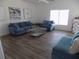 Inviting living room featuring comfortable blue sofas, modern artwork, and a bright window, creating a relaxing atmosphere at 3512 Osprey Cove Dr, Riverview, FL 33578