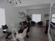 Open floor plan featuring a modern dining set, hardwood floors, and abundant natural light at 3512 Osprey Cove Dr, Riverview, FL 33578