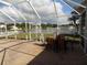 Covered and screened patio with outdoor seating overlooking the landscaped yard at 3512 Osprey Cove Dr, Riverview, FL 33578