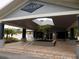 Community pavilion features a peaked roof, brick pavers, palm trees, landscaping, and a covered entrance at 3512 Osprey Cove Dr, Riverview, FL 33578