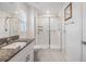 Bathroom boasts a glass-enclosed shower, granite countertop, and white subway tile at 36414 Well Hill Way, Zephyrhills, FL 33541