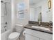 Bright bathroom featuring a vanity with granite countertop and a shower-tub combo at 36414 Well Hill Way, Zephyrhills, FL 33541
