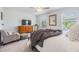 Bright bedroom with plush carpet, ceiling fan, dresser, and serene window views at 36414 Well Hill Way, Zephyrhills, FL 33541