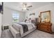 Inviting bedroom with a plush bed, decorative wall art and a rustic dresser at 36414 Well Hill Way, Zephyrhills, FL 33541