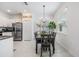 Well-lit dining space features modern lighting, a large window, and easy access to the kitchen at 36414 Well Hill Way, Zephyrhills, FL 33541