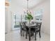 Elegant dining area with a modern chandelier, seating for six, and sliding door access to outdoor at 36414 Well Hill Way, Zephyrhills, FL 33541