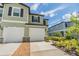 Two-story townhome featuring an attached garage and manicured landscaping at 36414 Well Hill Way, Zephyrhills, FL 33541