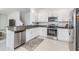 Modern kitchen featuring granite countertops, stainless steel appliances, and white cabinetry at 36414 Well Hill Way, Zephyrhills, FL 33541
