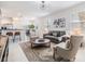 Stylish living room featuring an open layout connecting to the dining area and modern kitchen at 36414 Well Hill Way, Zephyrhills, FL 33541