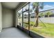 Screened patio offering views of the fenced backyard and lush palm trees at 36414 Well Hill Way, Zephyrhills, FL 33541