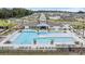 Community pool featuring ample seating and sunbathing areas, perfect for relaxation and recreation at 36414 Well Hill Way, Zephyrhills, FL 33541