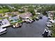 Aerial view of waterfront homes with private docks, boat lifts, and canal access at 386 Westwinds Dr, Palm Harbor, FL 34683