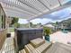 Backyard hot tub on the deck with a pergola above overlooking the canal at 386 Westwinds Dr, Palm Harbor, FL 34683
