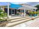 Backyard deck featuring outdoor seating and views of the waterfront, perfect for relaxing and entertaining at 386 Westwinds Dr, Palm Harbor, FL 34683