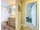 Bathroom features a shower-tub combo and a gray vanity with great lighting at 386 Westwinds Dr, Palm Harbor, FL 34683