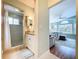 Bright bathroom featuring tiled shower, granite vanity, and charming nautical decor at 386 Westwinds Dr, Palm Harbor, FL 34683