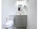Clean, modern bathroom with white walls, grey vanity, and stylish tile accents for a fresh look at 386 Westwinds Dr, Palm Harbor, FL 34683