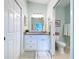 Bathroom with tile flooring, granite countertop, and a view of the toilet and shower at 386 Westwinds Dr, Palm Harbor, FL 34683