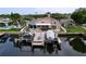 Stunning waterfront home with a private dock, boat lifts, outdoor patio, and serene water views at 386 Westwinds Dr, Palm Harbor, FL 34683