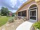 Inviting walkway leading to the home's entrance with beautiful plants and welcoming decor at 386 Westwinds Dr, Palm Harbor, FL 34683