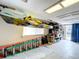 Spacious garage with kayak lift and storage solutions for recreational equipment and accessories at 386 Westwinds Dr, Palm Harbor, FL 34683