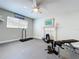 Home gym featuring a ceiling fan, tv, and fitness equipment at 386 Westwinds Dr, Palm Harbor, FL 34683