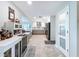 Spacious kitchen with a bar area, stainless steel appliances, and access to other living spaces at 386 Westwinds Dr, Palm Harbor, FL 34683