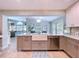 Kitchen island with farmhouse sink, gray cabinets, and view to the living room at 386 Westwinds Dr, Palm Harbor, FL 34683