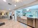 Open concept kitchen with a large island, farmhouse sink, granite countertops and stainless steel appliances at 386 Westwinds Dr, Palm Harbor, FL 34683