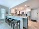 Bright kitchen with stainless steel appliances, island with seating, and ample cabinet space at 386 Westwinds Dr, Palm Harbor, FL 34683