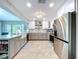 Fully equipped kitchen with gray cabinets, stainless steel appliances, and center island with sink at 386 Westwinds Dr, Palm Harbor, FL 34683