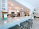 Bright, open kitchen featuring a bar-style countertop and stainless steel appliances at 386 Westwinds Dr, Palm Harbor, FL 34683