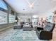 Open living room featuring a ceiling fan, large windows, and comfortable seating arrangement at 386 Westwinds Dr, Palm Harbor, FL 34683