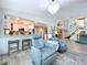 Inviting living room with kitchen view, chandelier, comfortable seating, and tile flooring at 386 Westwinds Dr, Palm Harbor, FL 34683