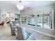 Bright living area with a decorative chandelier, comfortable seating, and views of the pool area at 386 Westwinds Dr, Palm Harbor, FL 34683