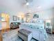 Bright main bedroom featuring luxury vinyl flooring, a seating area, and an en suite bathroom at 386 Westwinds Dr, Palm Harbor, FL 34683