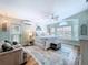 Main bedroom with en suite bath features coastal decor, a ceiling fan, and an exterior access door at 386 Westwinds Dr, Palm Harbor, FL 34683