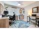 Bright home office features a ceiling fan, a large window, two desks, office chairs, and decorative accents at 386 Westwinds Dr, Palm Harbor, FL 34683
