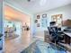 View from the home office looking into the dining and living rooms, showing an open concept design at 386 Westwinds Dr, Palm Harbor, FL 34683