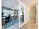 Home office with sliding glass door, ceiling fan, window with blinds, desk, office chair and decorative accents at 386 Westwinds Dr, Palm Harbor, FL 34683