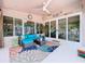 Bright sunroom with coastal decor, comfortable seating, and large windows providing plenty of natural light at 386 Westwinds Dr, Palm Harbor, FL 34683