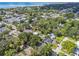 Aerial view of a residential area featuring both homes and condos surrounded by lush greenery and waterway views at 4009 S Renellie Dr, Tampa, FL 33611