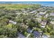 Aerial perspective of a residential area near a bay, featuring a mix of housing and commercial properties amid green trees at 4009 S Renellie Dr, Tampa, FL 33611